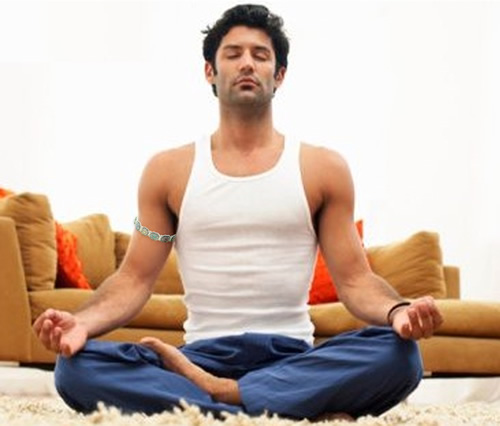 man meditating wearing bangle